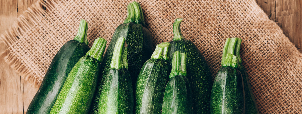 Fresh farmer organic zucchini on a wooden background