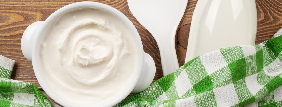 Sour cream in a bowl and milk bottle